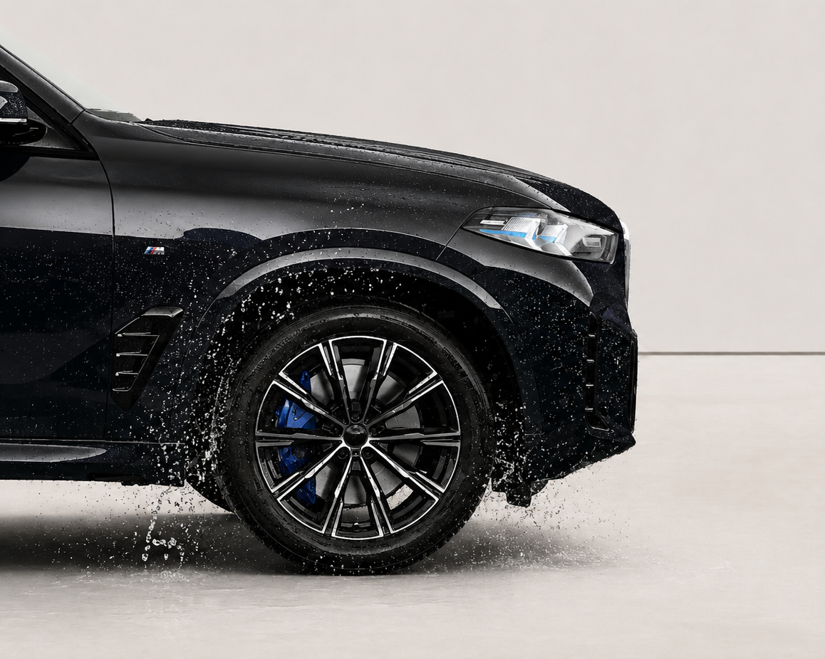 Black car with wet tires on a gray background. With wheel ceramic coating by element care melbourne
